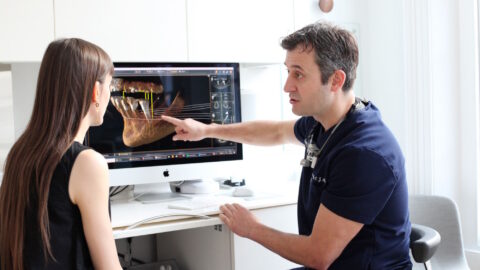 Dentist Explaining A Procedure To A Patient